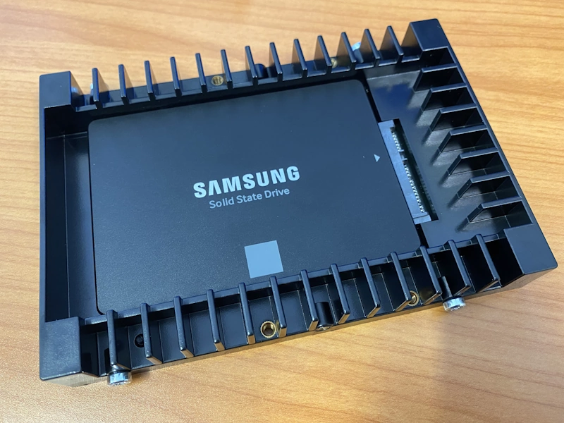 <i>Photo 10 - SSD and drive adapter with screws.</i>